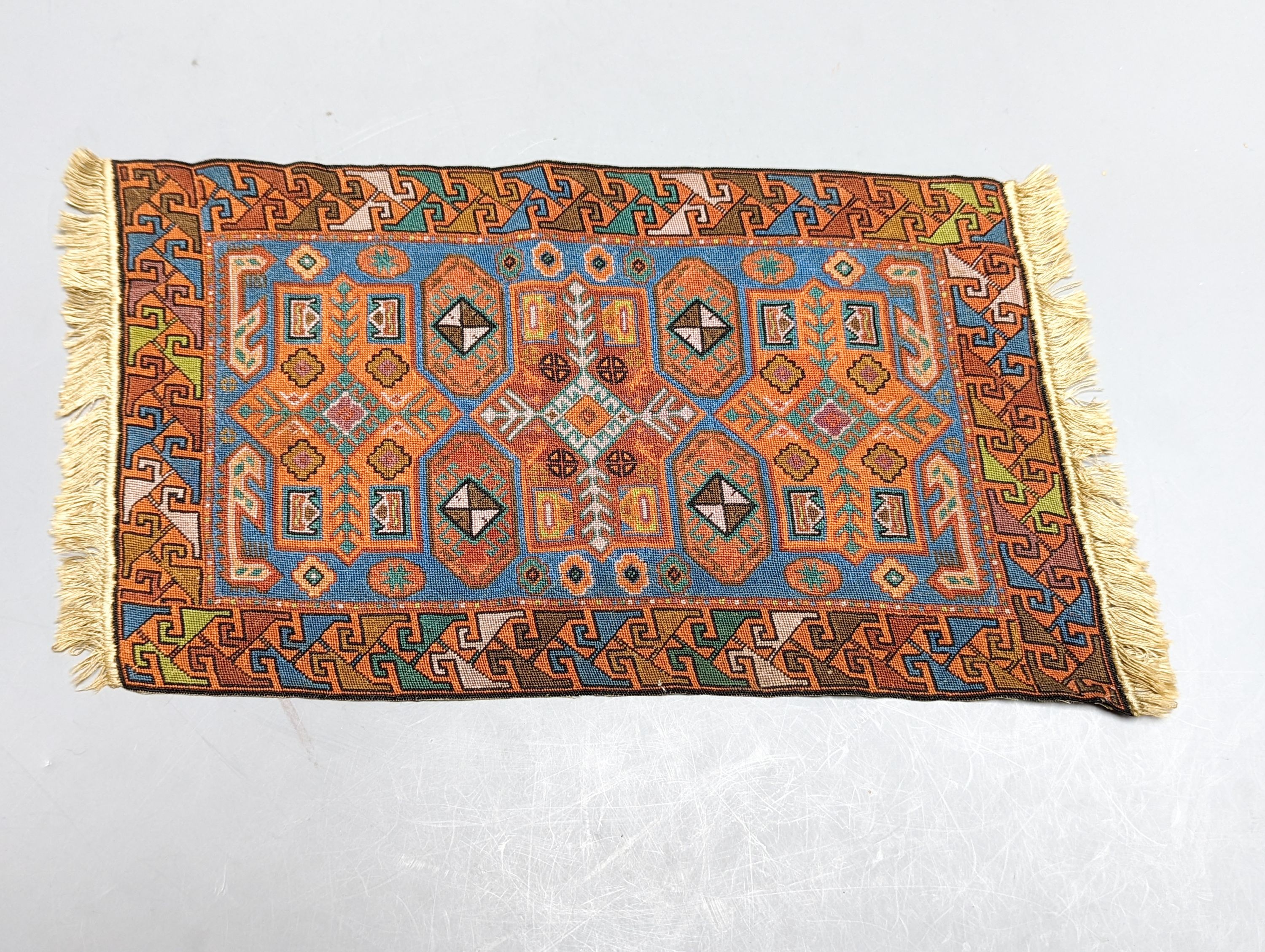 A Caucasian style petit point miniature rug 33x20cm